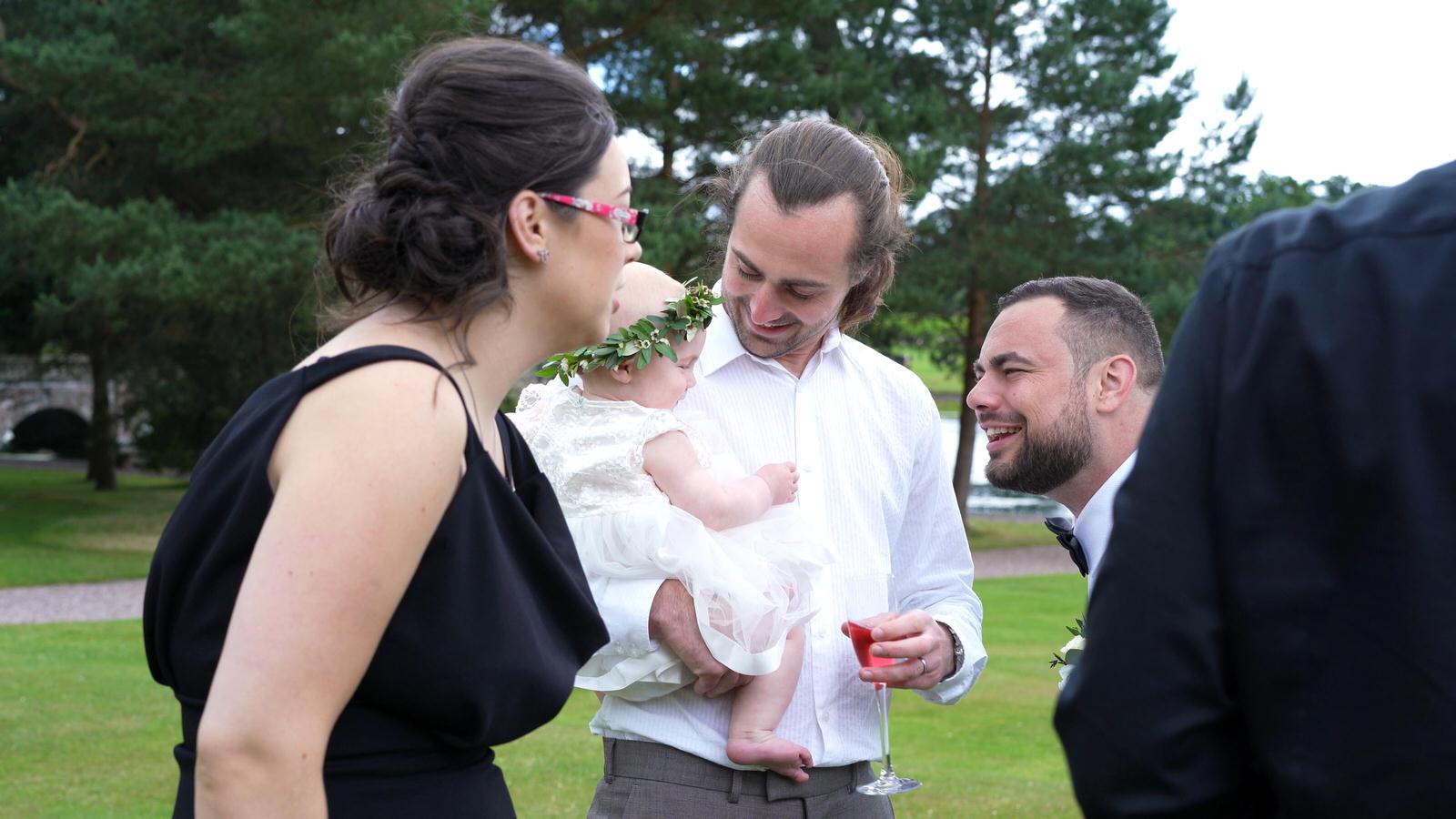 guests fuss over a baby flowergirl