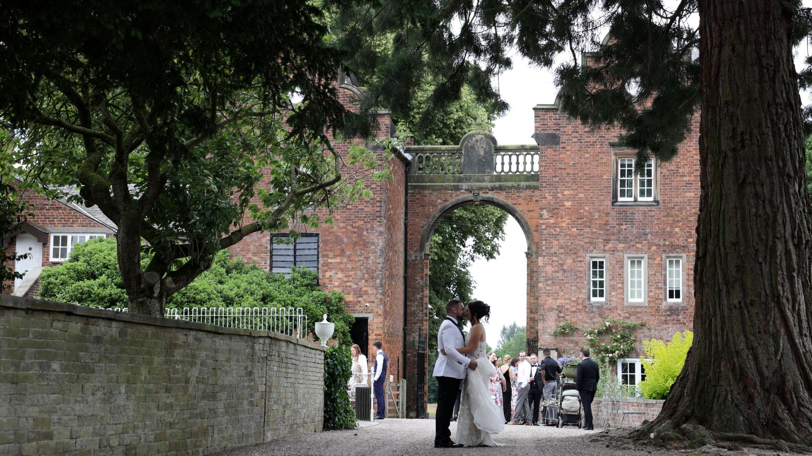 video still of couple enjoying a kiss during reception at Capesthorne