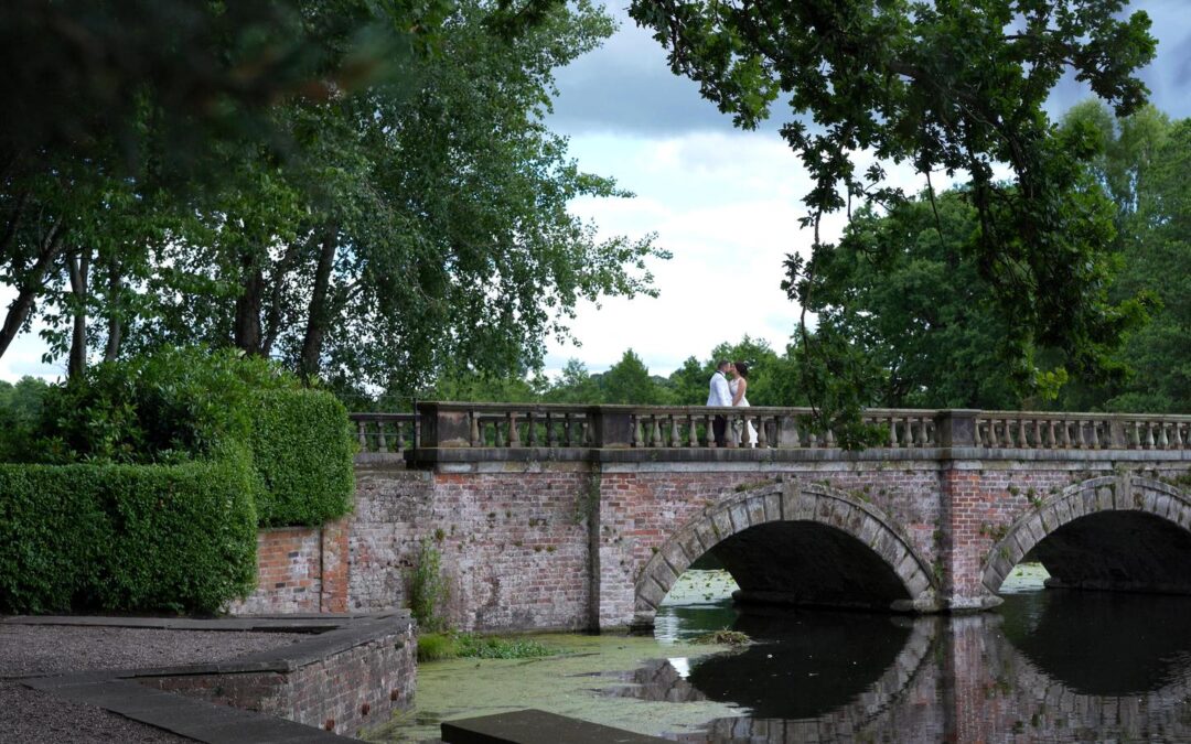 video still of bride and groom on lake bridge at Capesthorne