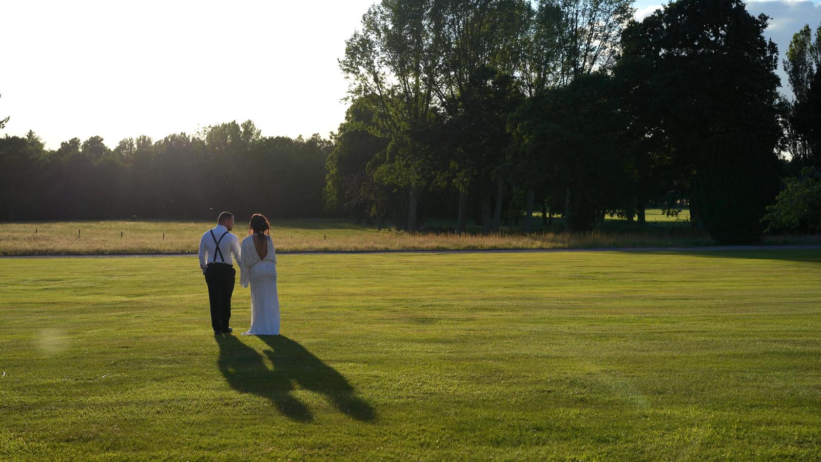 bride and groom walk around Capesthorne hall gardens