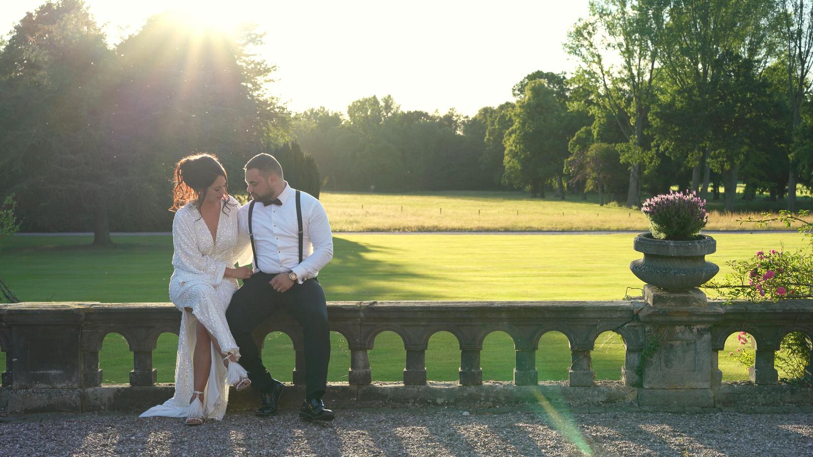 couple sit together in golden hour in Capesthorne hall gardens