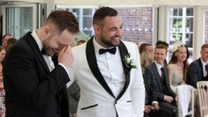 groom stands with best man before ceremony at Capesthorne Hall