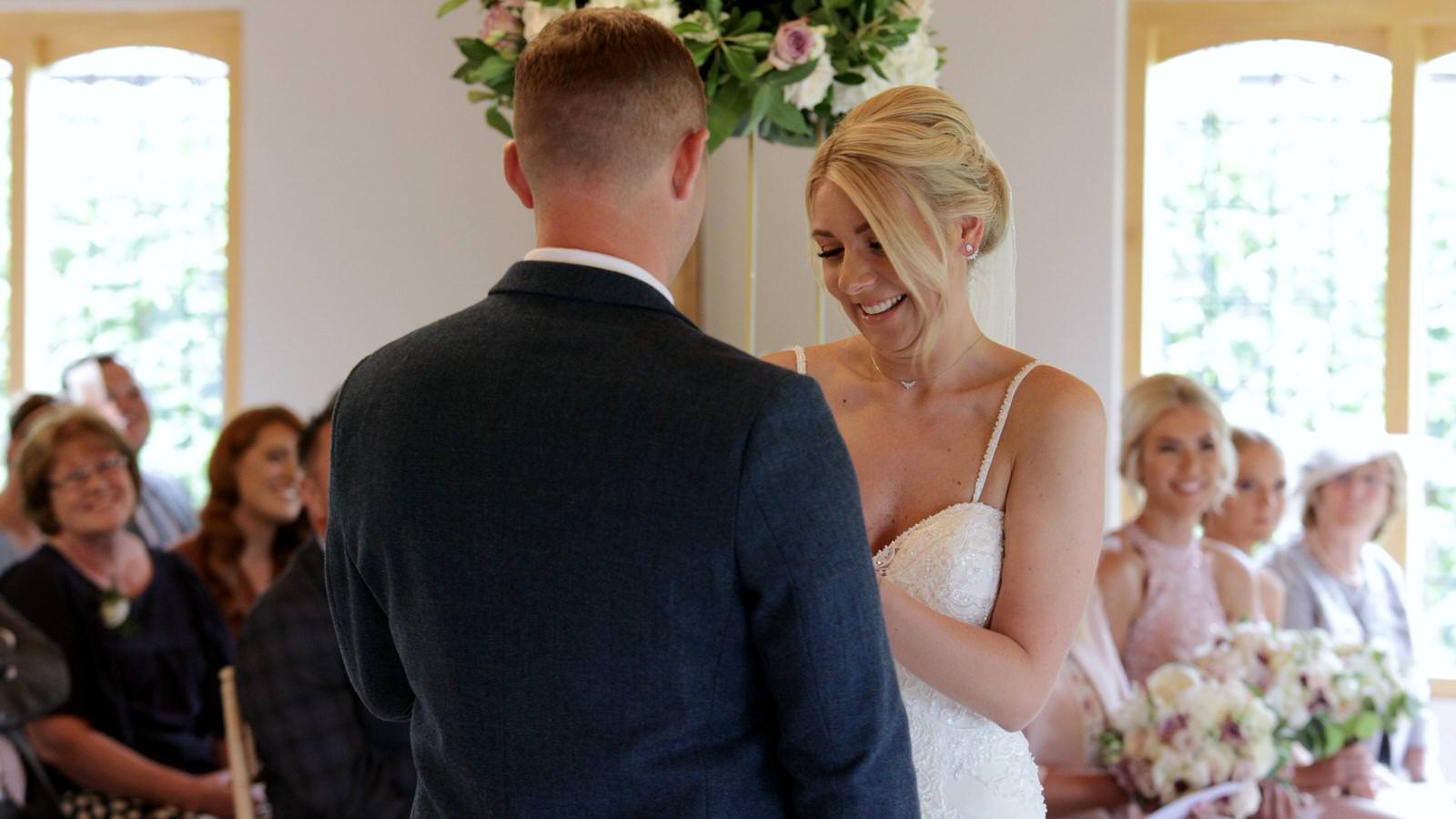 exchanging wedding rings in ceremony room at Merrydale