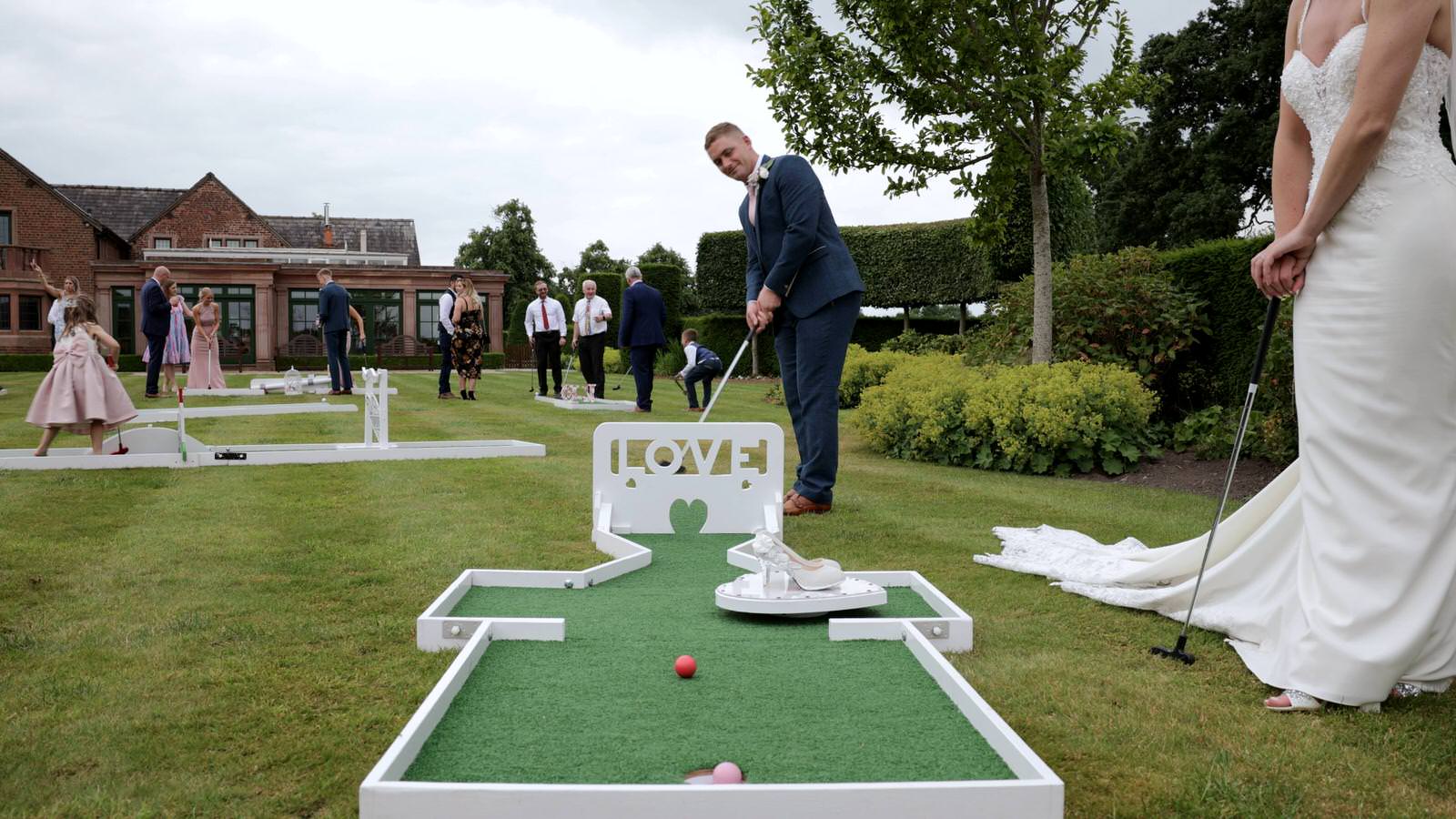 bride and groom play crazy golf