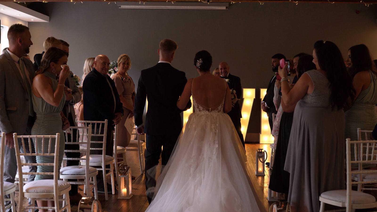 video still of bride walking down the aisle at Castlefield Rooms