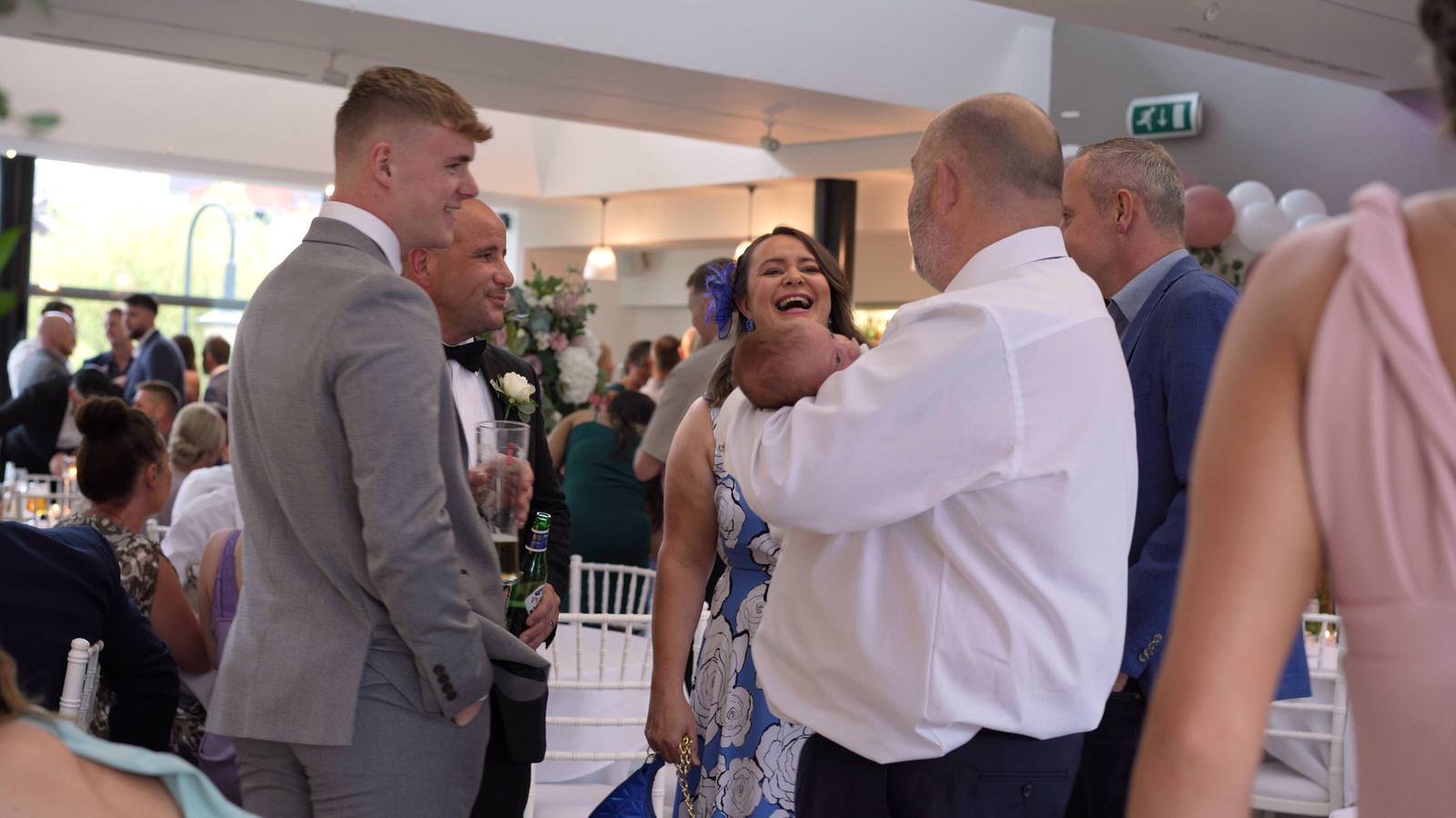 guests mingle and laugh during wedding reception