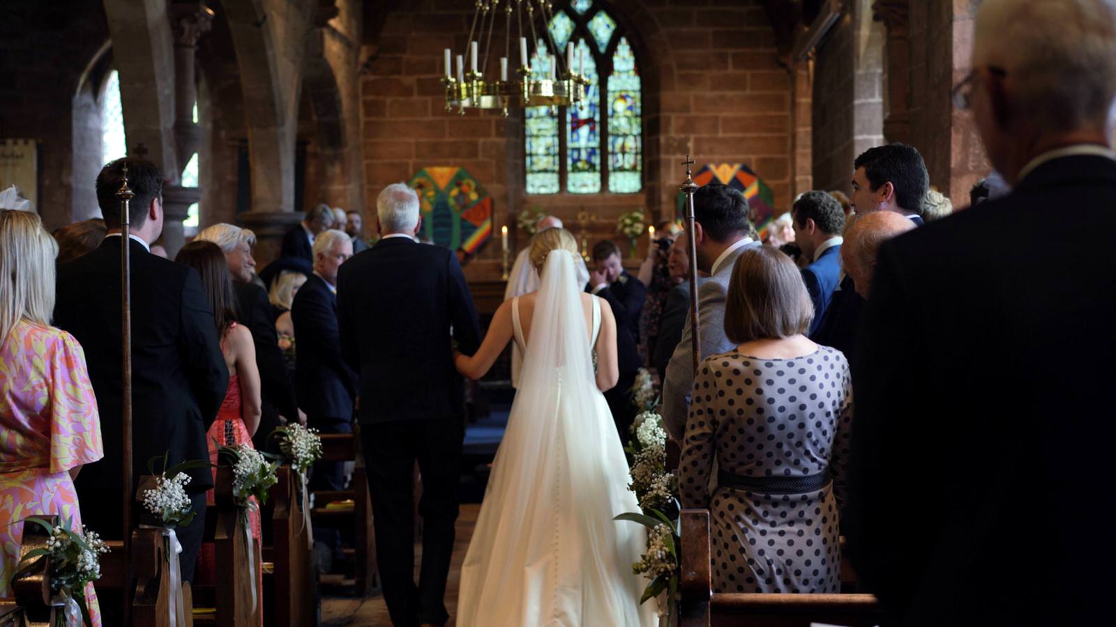 bride walks down the aisle at St Nicholas’s Church