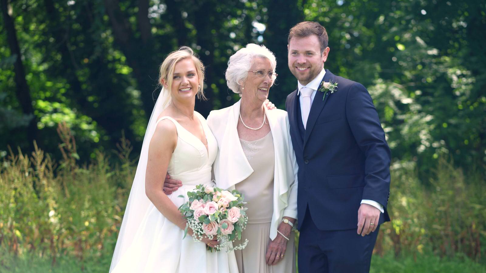 couple pose with grandma for wedding photos