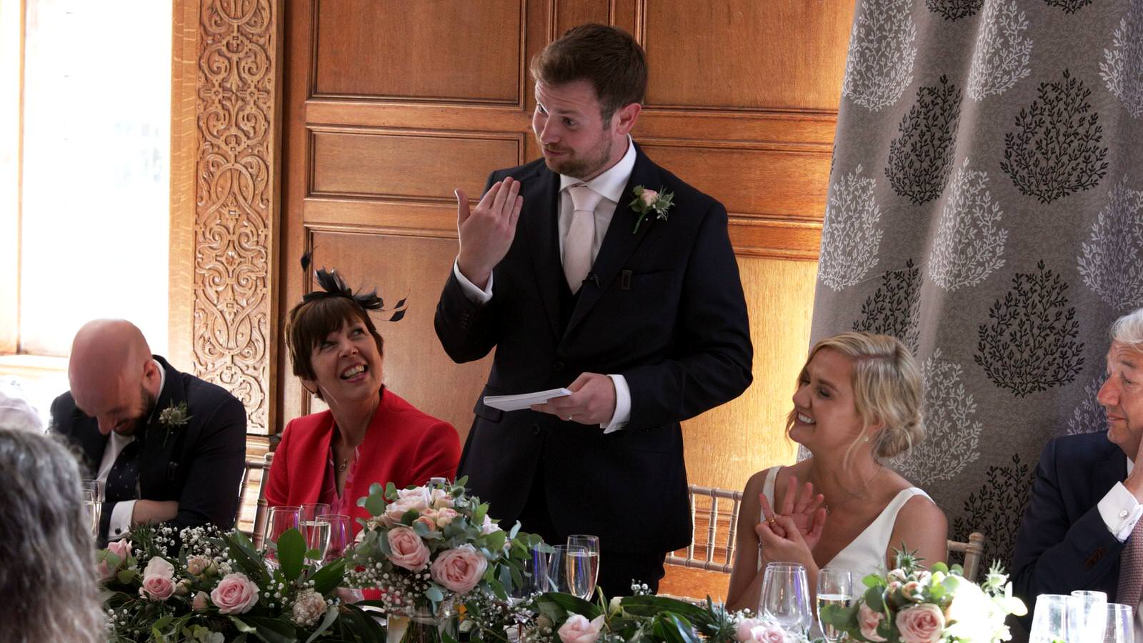 groom tries to stop crying during wedding speech