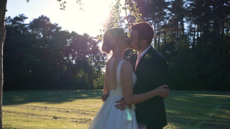 video still of couple kissing during evening light