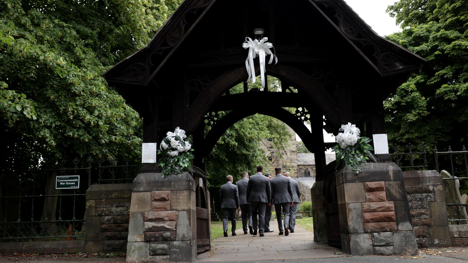 groomsmen walk towards st marys church penwortham