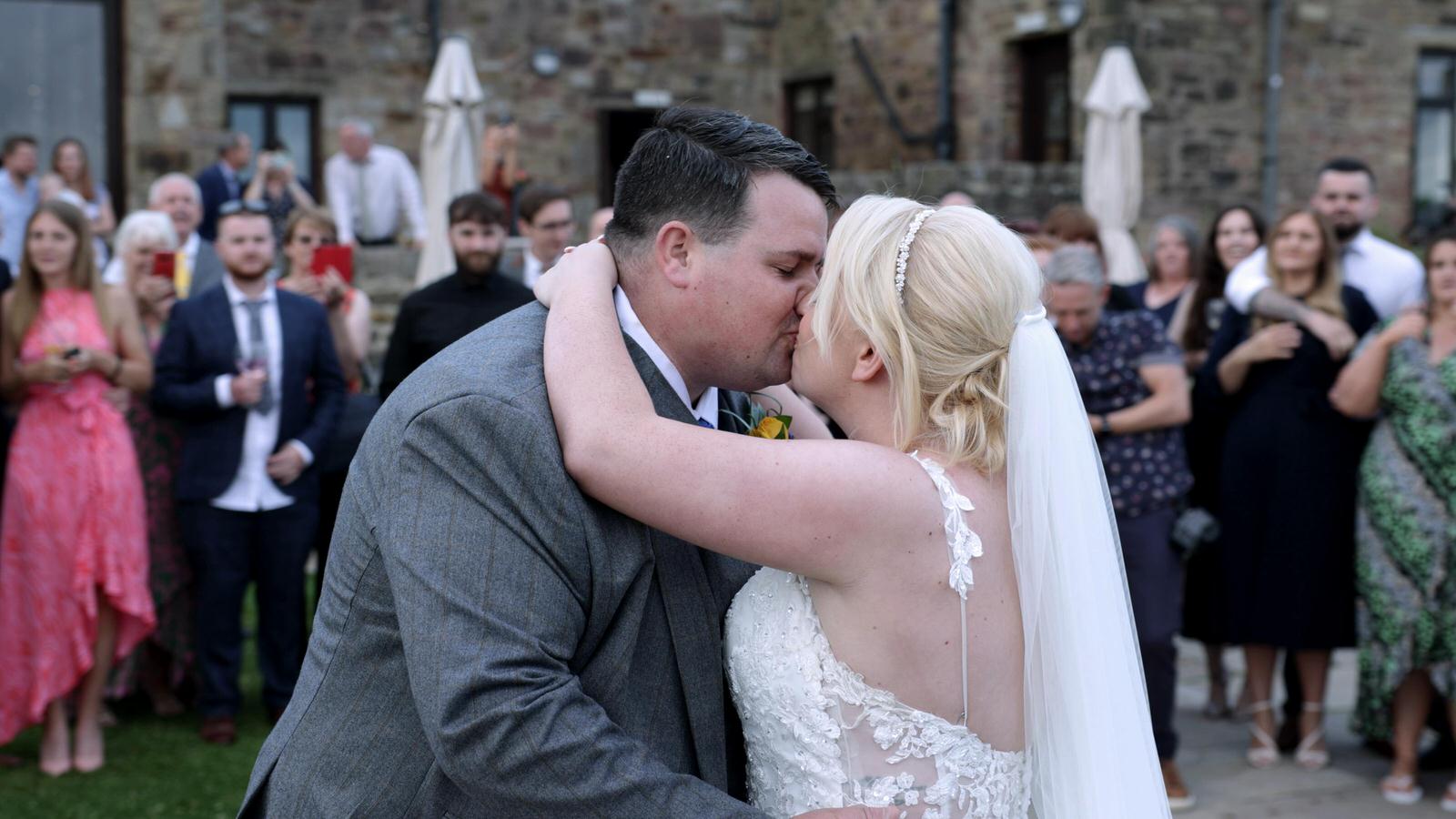 couple kiss during first dance outside at Beeston Manor