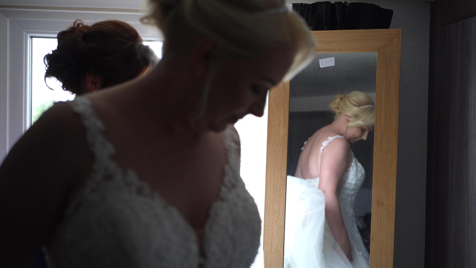 reflection of bride in the bedroom mirror