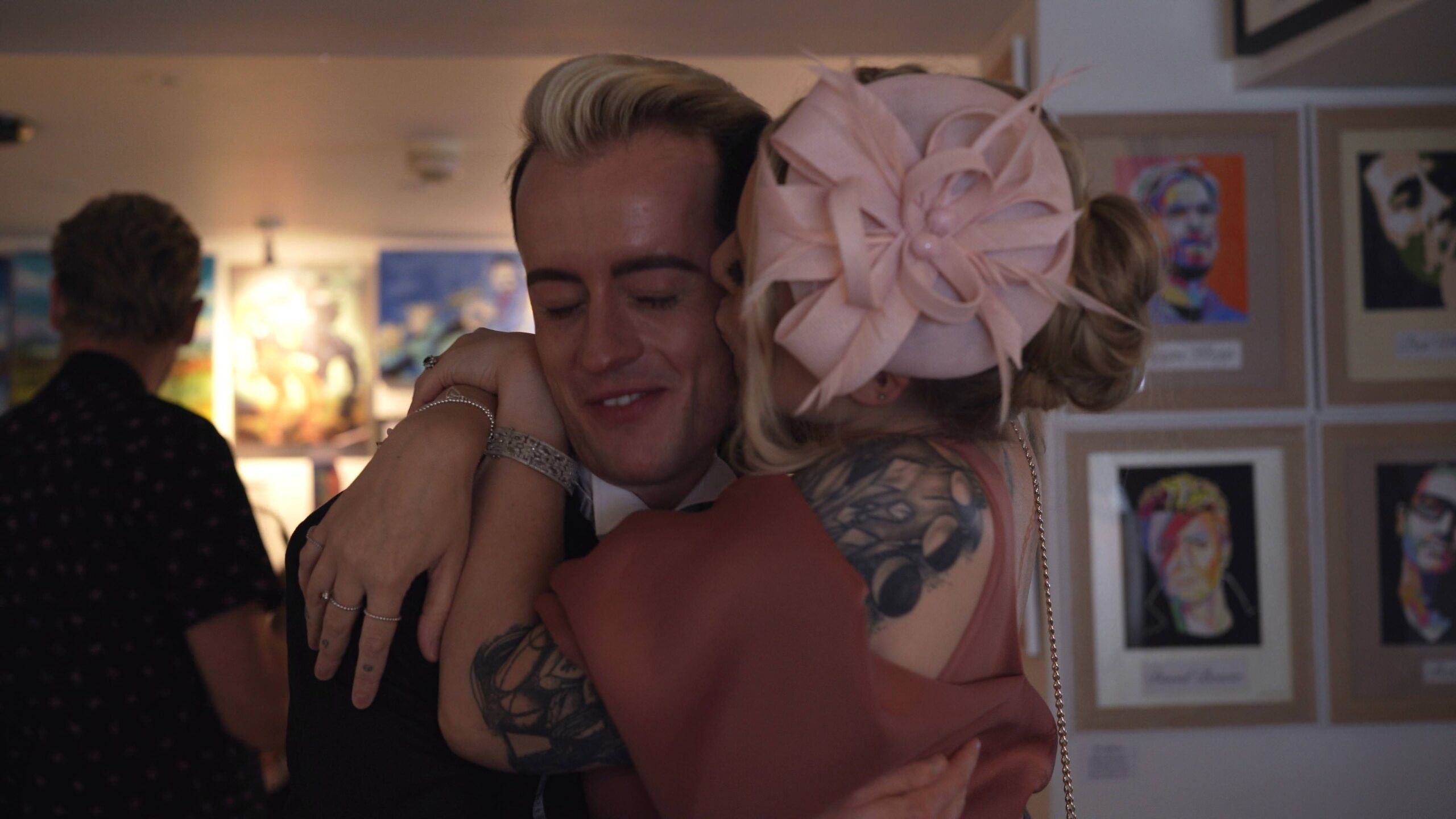 wedding guest hugs groom during reception