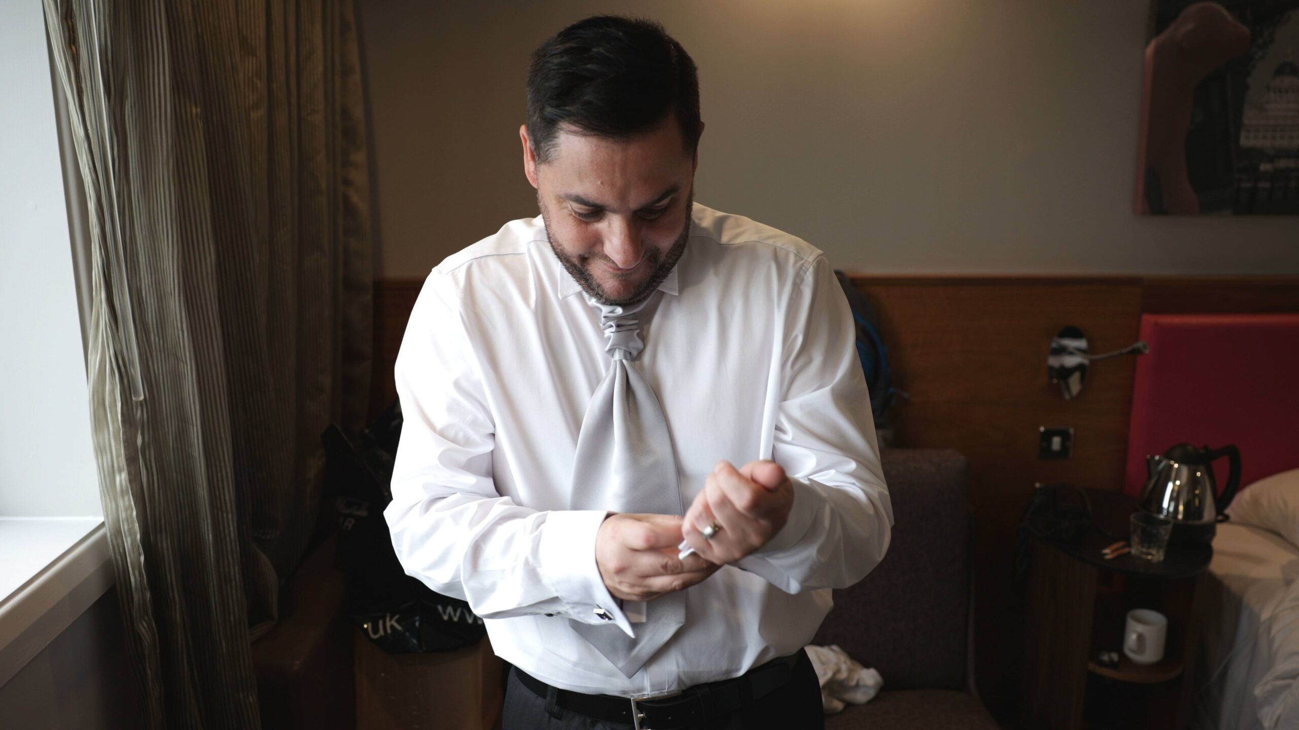 groom fastens cufflinks