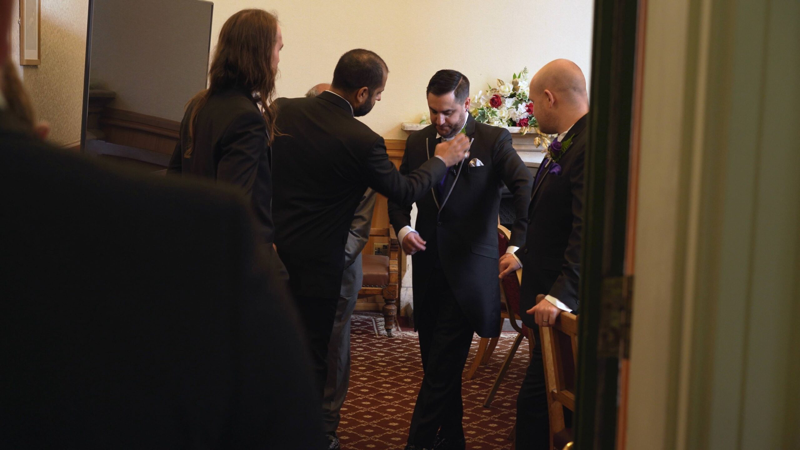 groomsmen fix ties before walking down the aisle