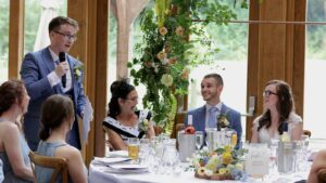 best man makes the couple laugh during speech
