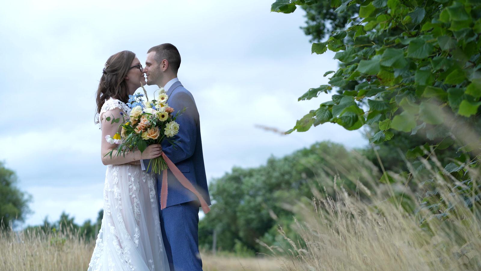 shot of couple kissing in long grass in cheshire