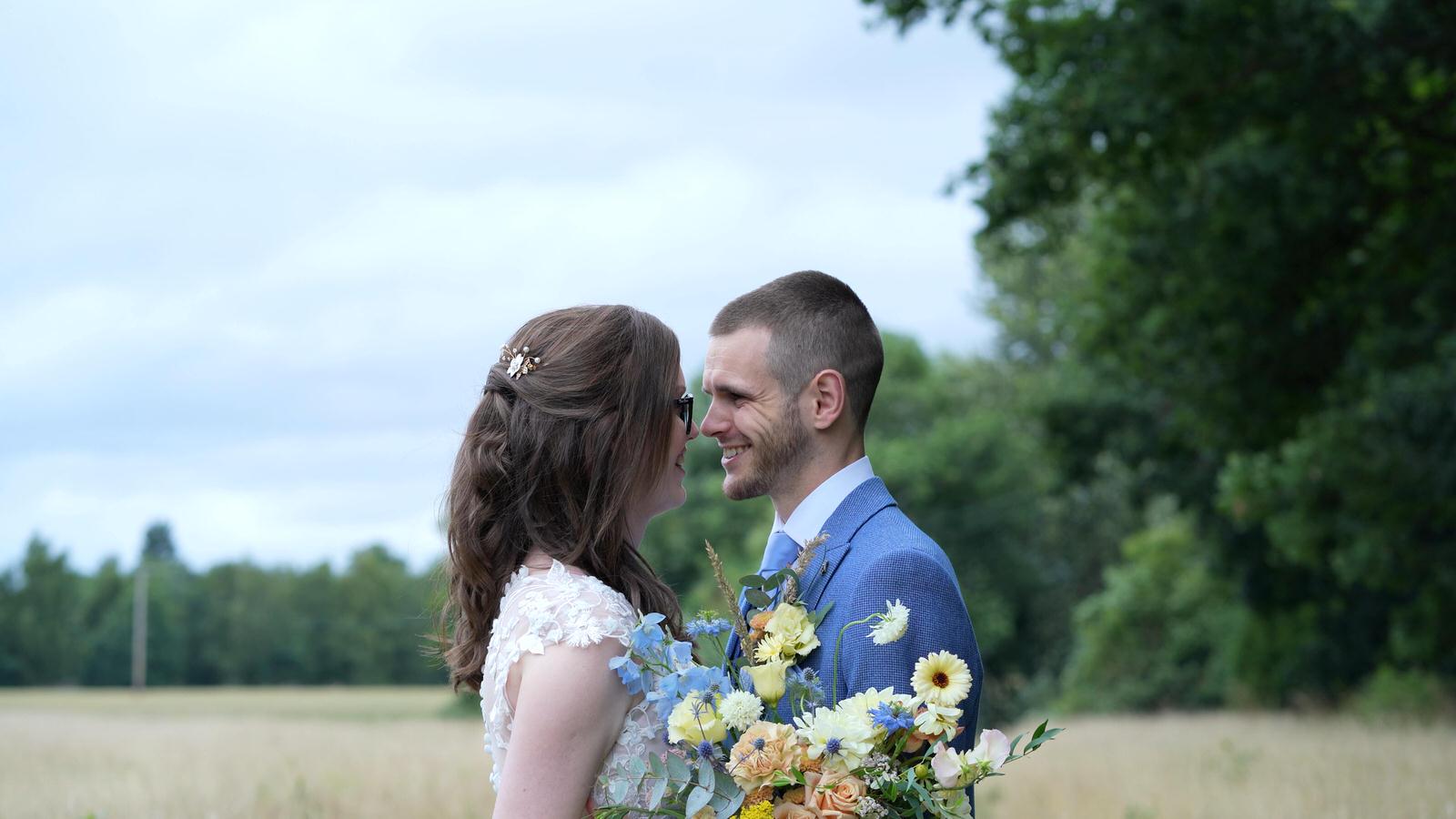 Kerry and Nicks Oaktree Peover wedding 30 couple smile at each other whilst being filmed at oaktree of peover