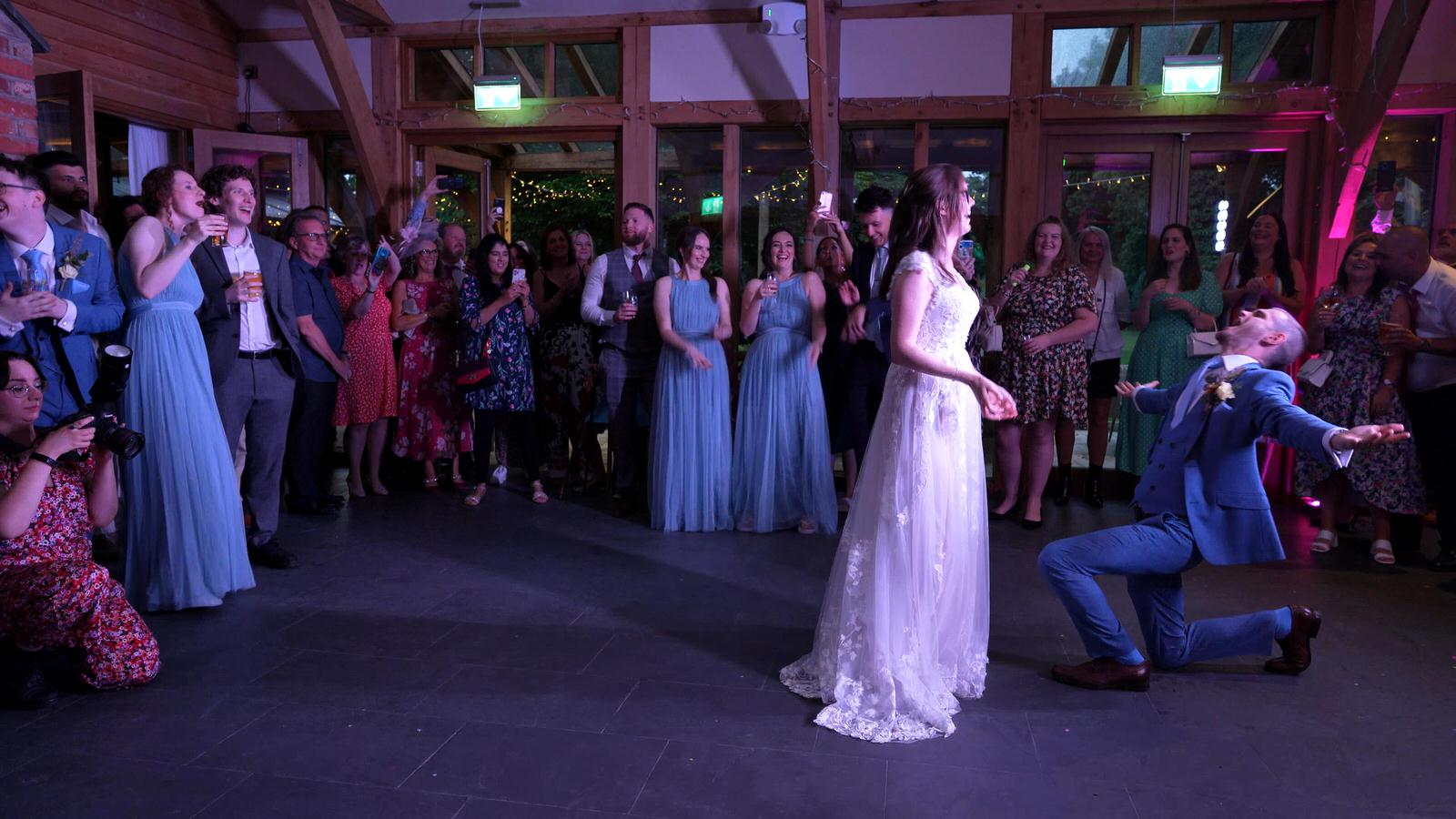 Kerry and Nicks Oaktree Peover wedding 35 groom throws his arms open during dance