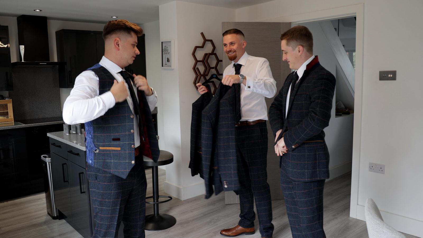 Groom gets ready at home with his groomsmen