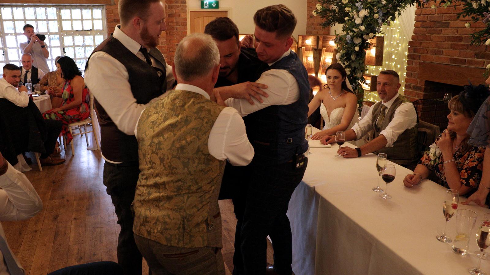 guests help the singing waiter after his fall