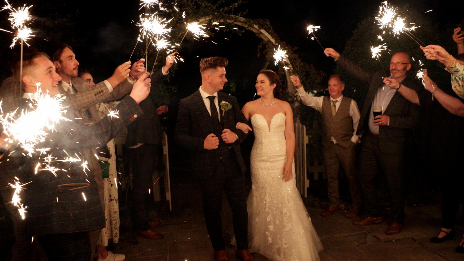 couple pose for a sparkler shot at Charnock Farm