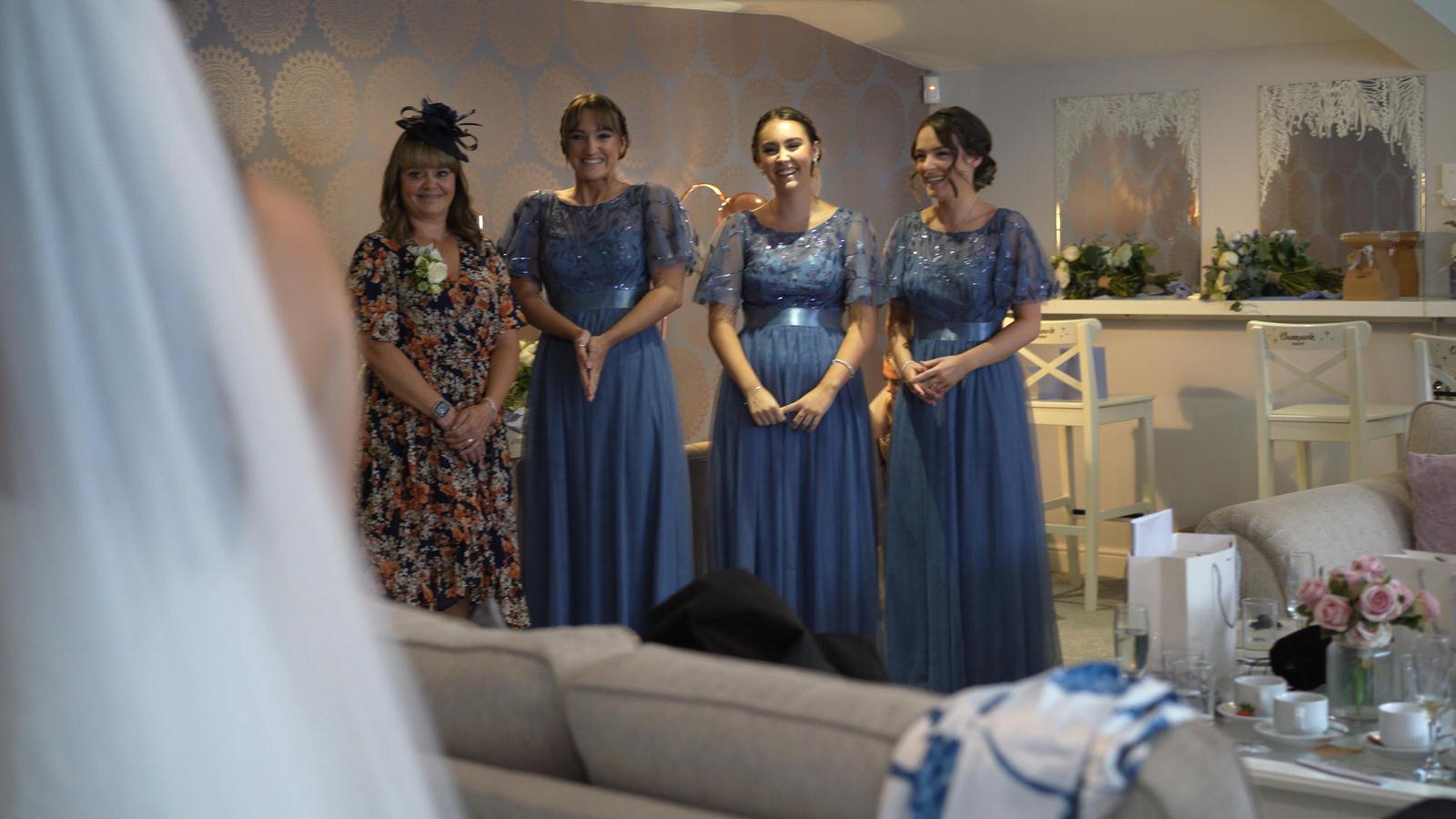 the bridesmaids react to the bride being ready