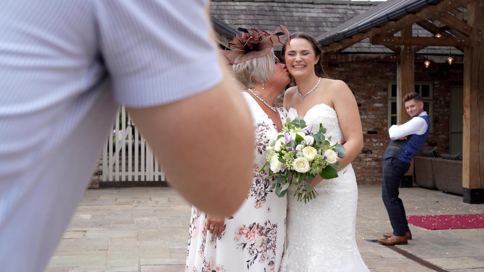 groom photobombs a photo of his new wife and mum