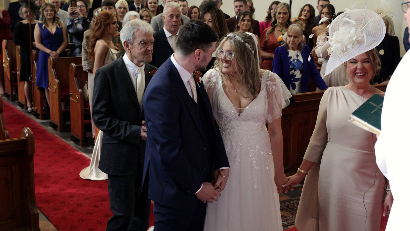 Hannah and Jakes Lancashire Farm Wedding Video 14 couple smile at each other at their wedding ceremony