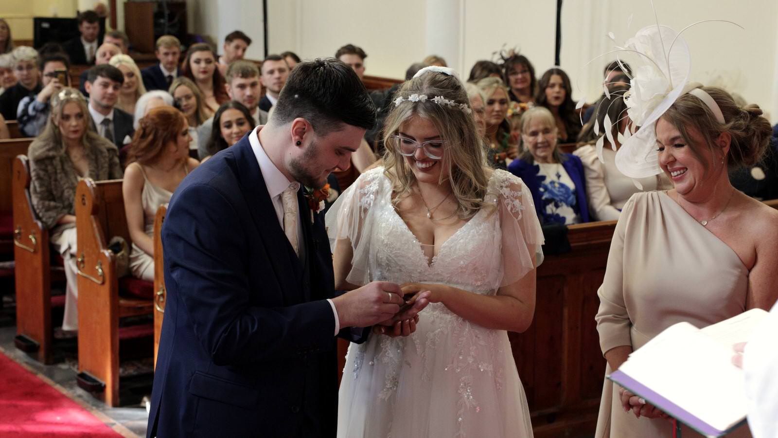 couple exchange wedding rings during Holy Trinity ceremony