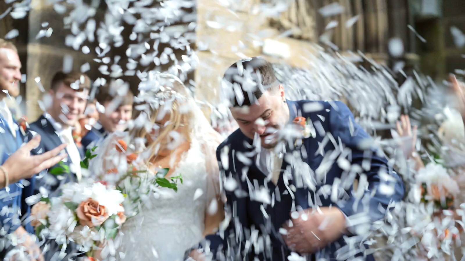 Hannah and Jakes Lancashire Farm Wedding Video 19 video still of so much white confetti outside holy trinity church