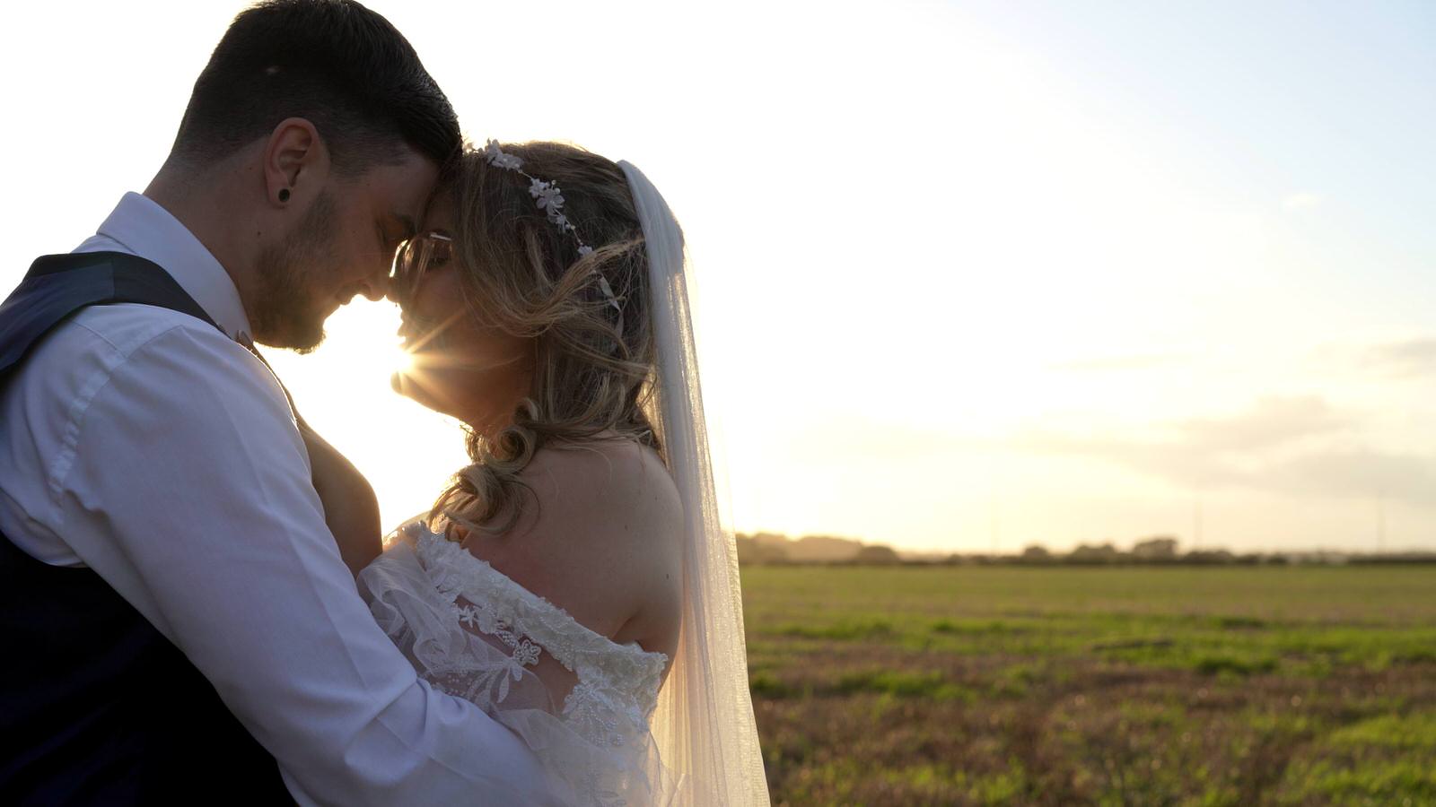 Hannah and Jakes Lancashire Farm Wedding Video 33 natural light video still of newlywed couple in field