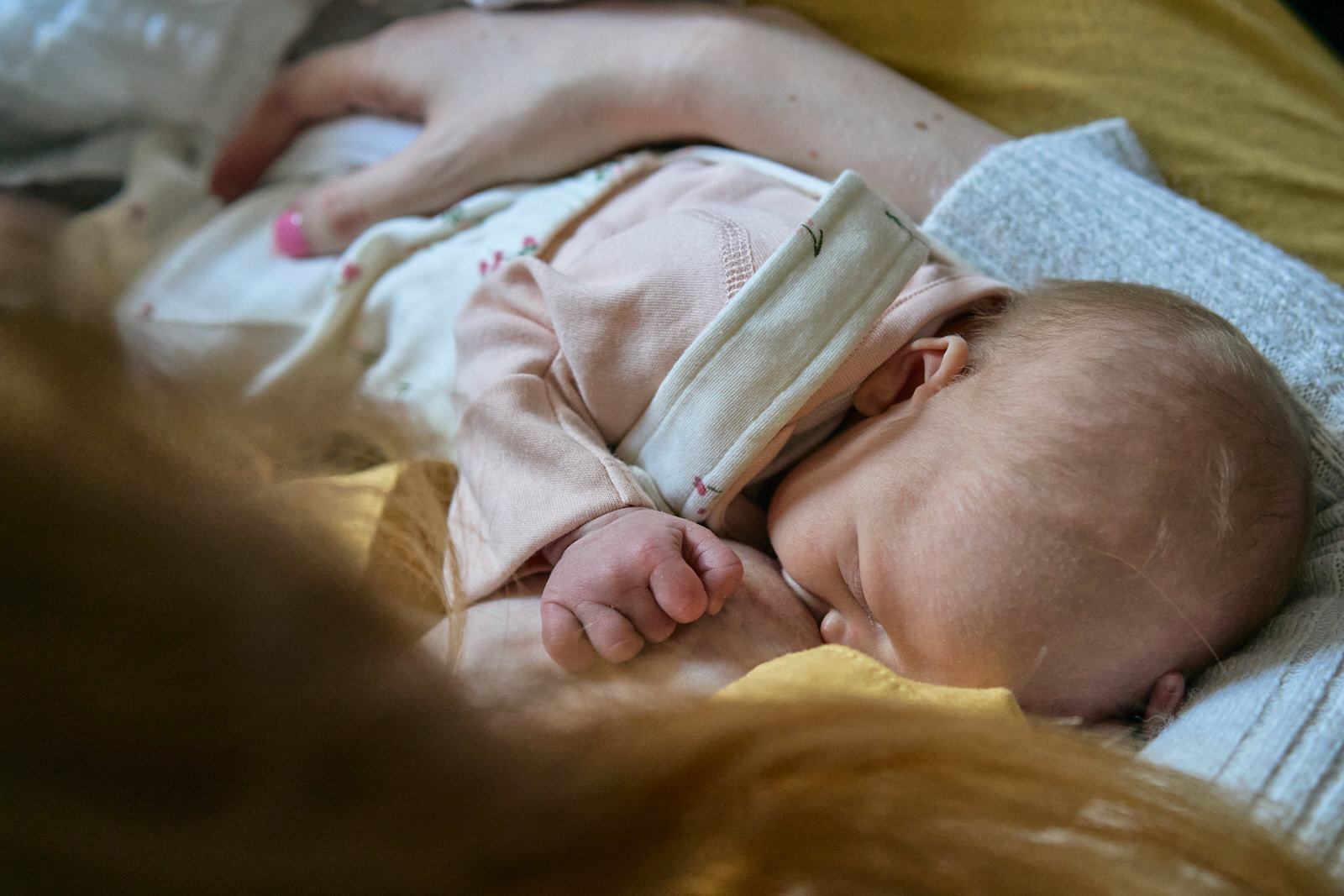 natural photograph of a newborn baby breastfeeding