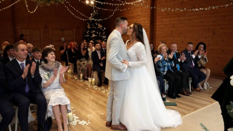 wide video shot of wedding guests clapping during ceremony