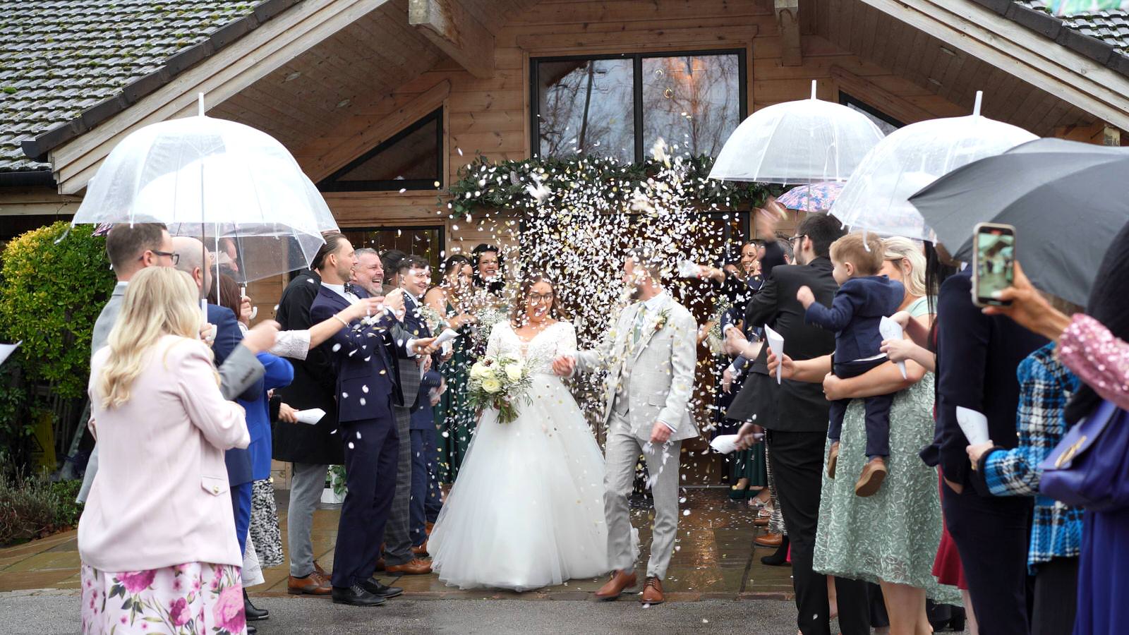 video still of confetti throwing outside Styal Lodge in the rain