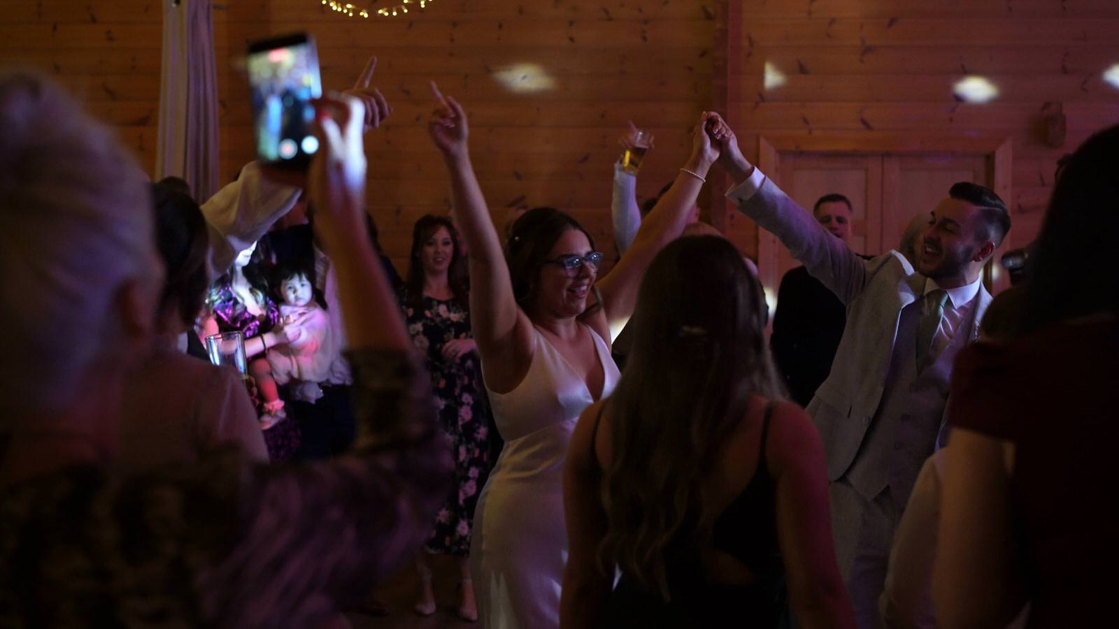 couple dance in the middle of their guests at Styal Lodge winter wedding