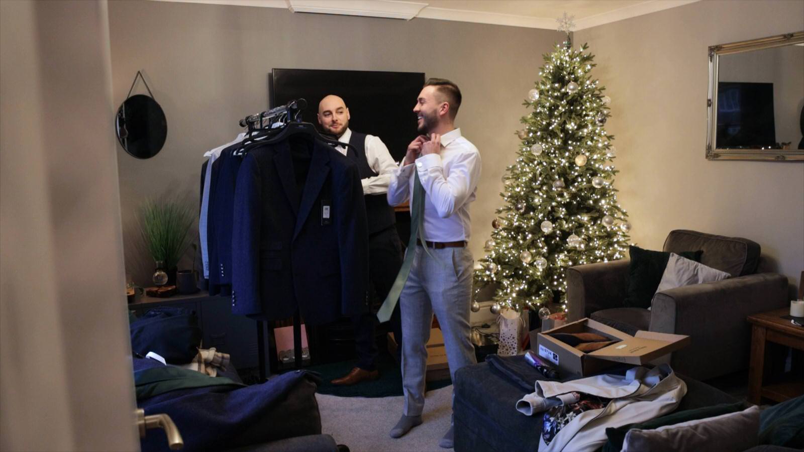 groom gets dressed for his christmas wedding