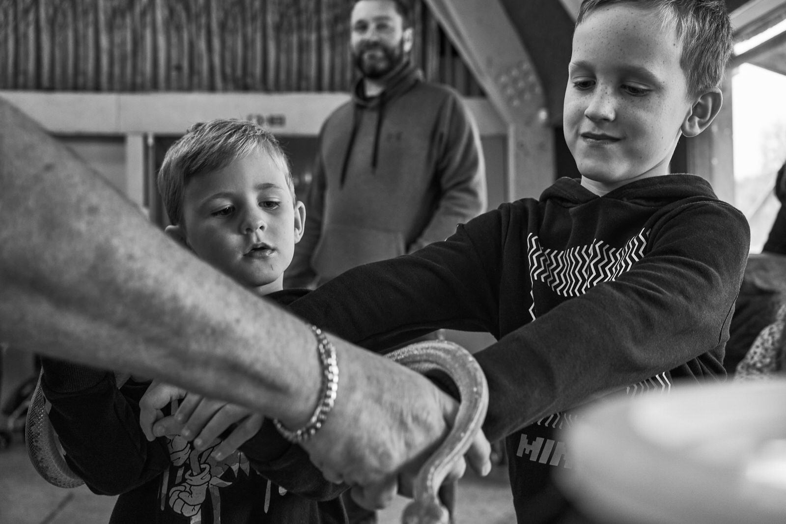two children get close to a snake for the first time during a day out at Brockholes