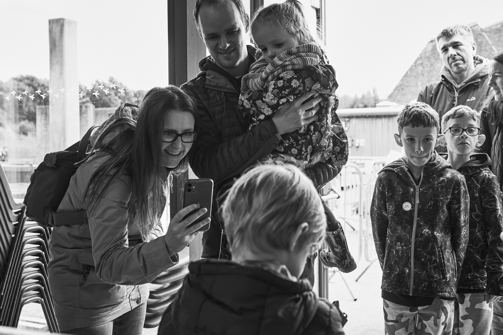 A mum takes a photo of her child holding a snake at Brockholes