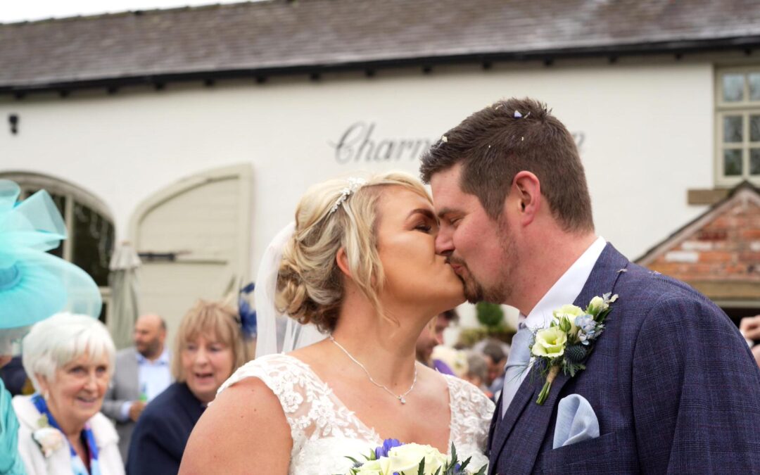 newlyweds kiss outside Charnock Farm