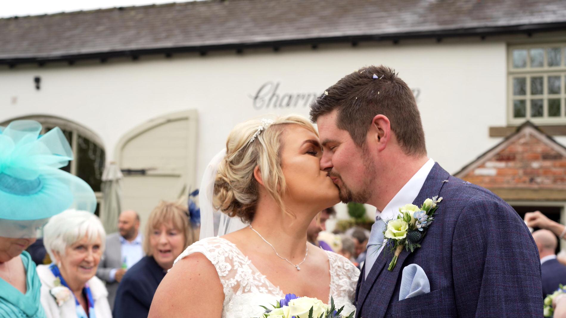 newlyweds kiss outside Charnock Farm