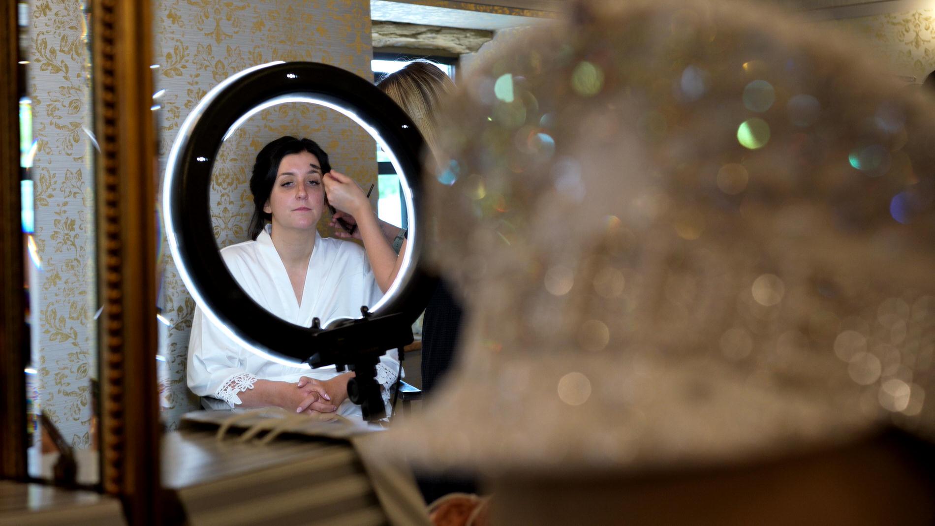 Courtney Dan Wharfdale Grange Wedding Video 2 bride gets her makeup done in front of a light ring