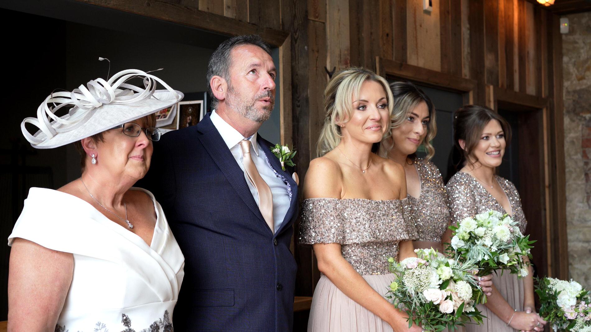 dad and bridesmaids look emotional seeing the bride for the first time