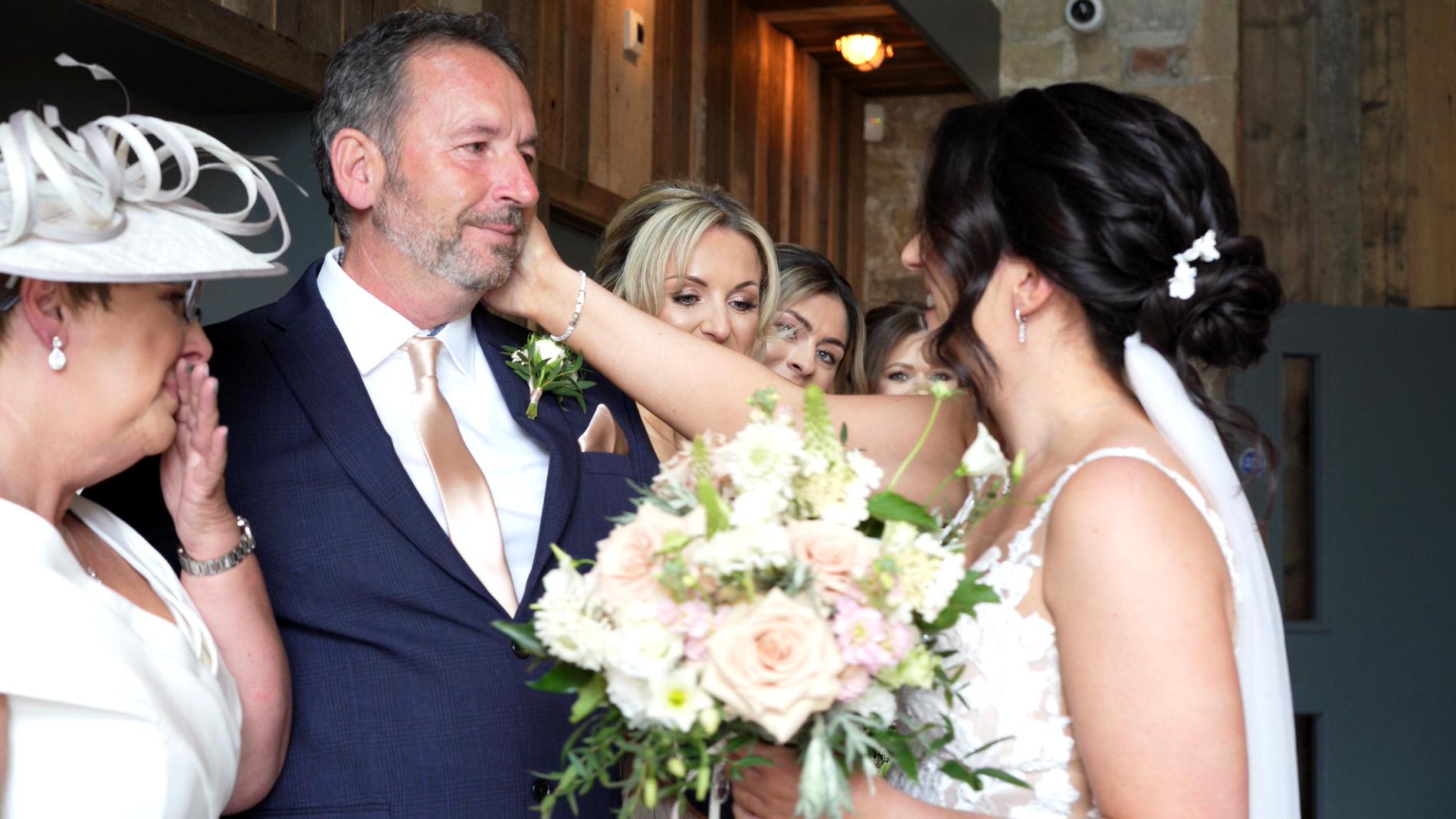 bride reaches out for her dad who's emotional at Wharfdale Grange in Yorkshire