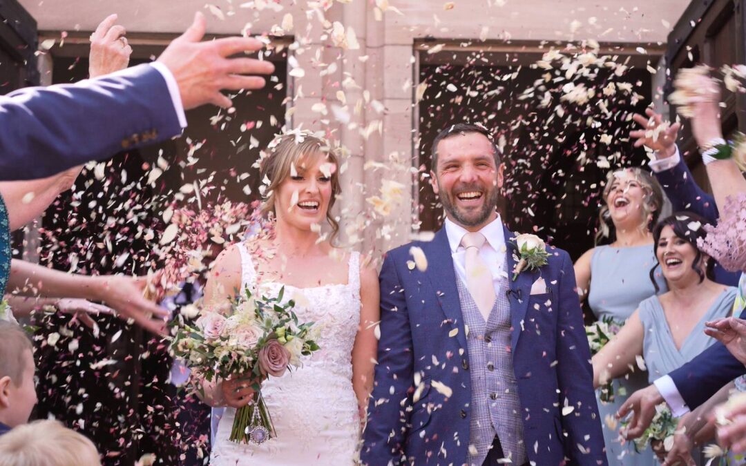guests throw handfuls of confetti outside St Werburgh's Church chester