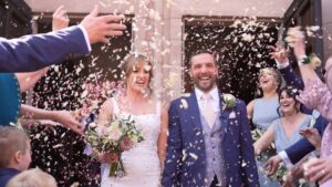 guests throw handfuls of confetti outside St Werburgh's Church chester