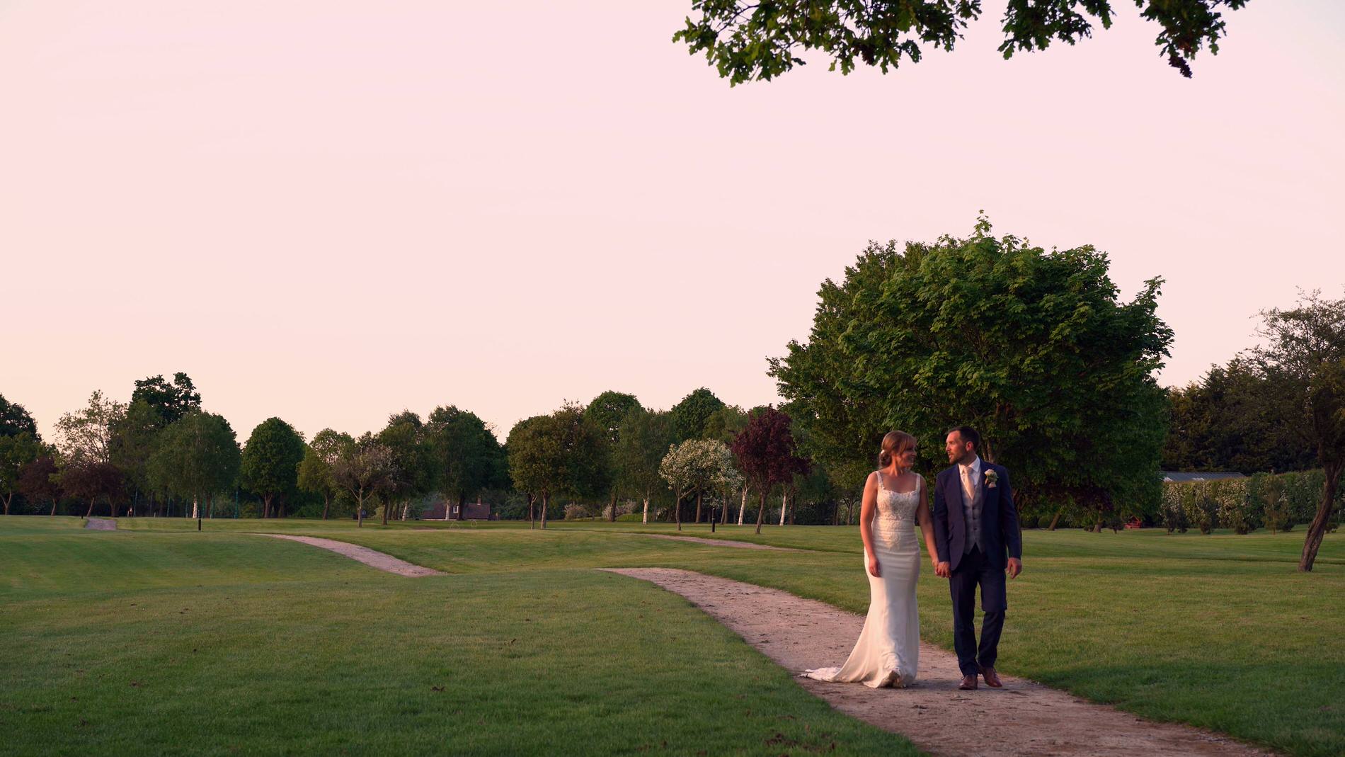 the couple stroll around the green at Pryors Hayes Golf Club