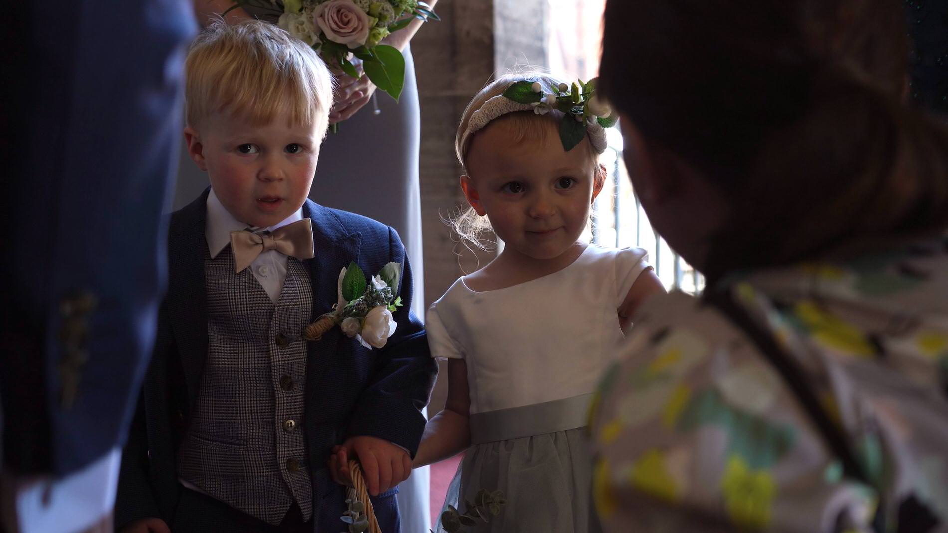 a flowergirl and pageboy wait to walk down the aisle in Chester