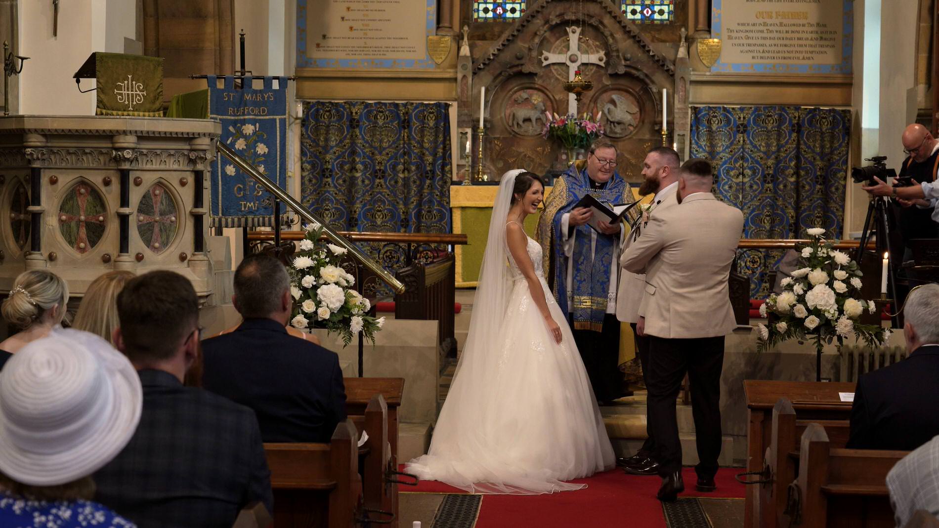 a couple laugh as they exchange rings in st mary the virgin church in rufford